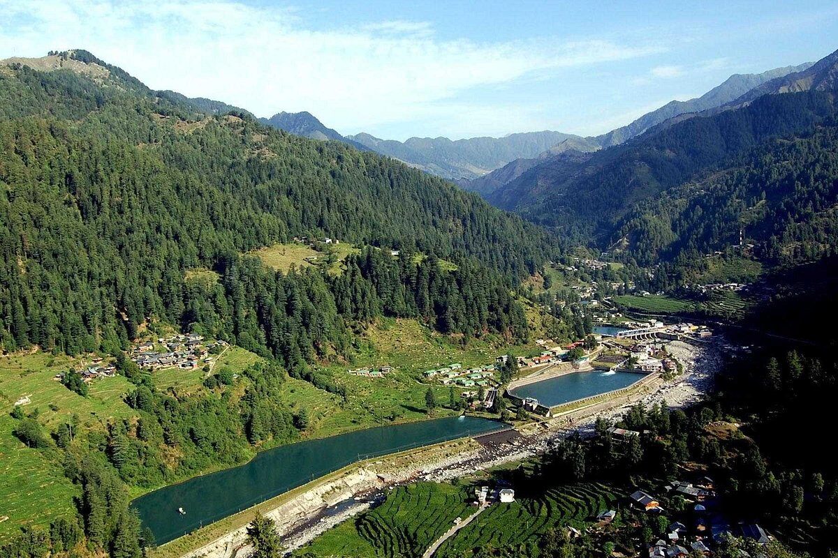 Beautiful landscape of Barot Valley Himachal Pradesh showing lush green hills and Uhl river