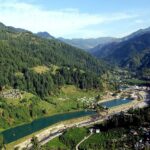 Beautiful landscape of Barot Valley Himachal Pradesh showing lush green hills and Uhl river